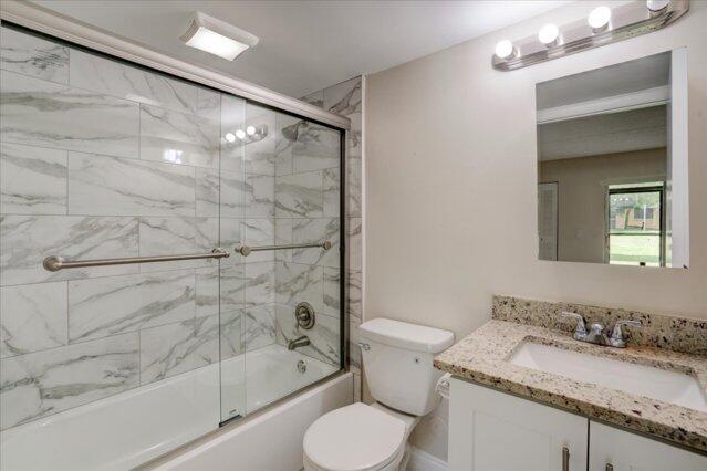 1104 Meadows Circle Boynton Beach, FL 33436 - Photo 18 of 27 a bathroom with a granite countertop sink toilet and shower