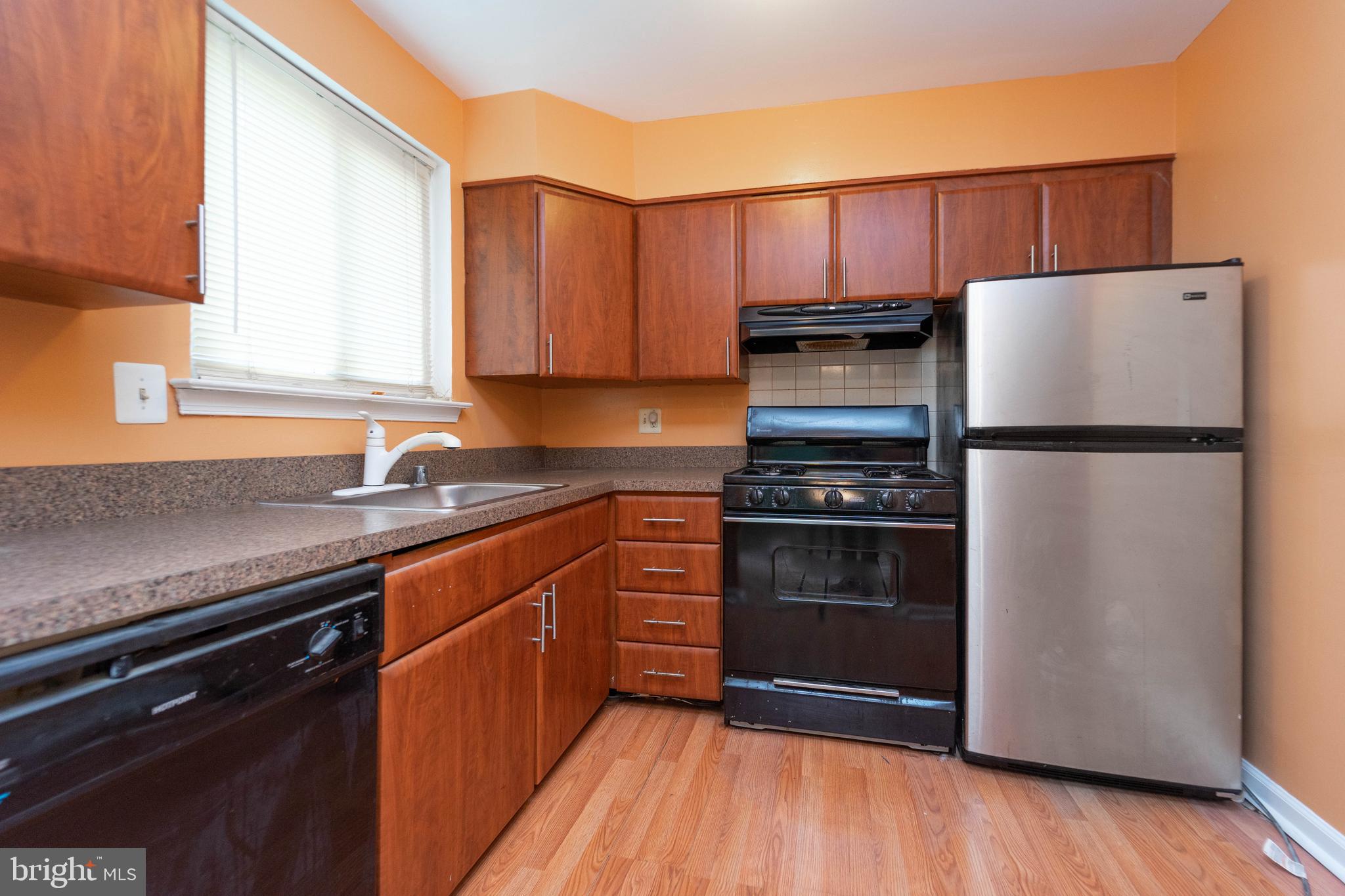 1923 Addison Road South District Heights, MD 20747 - Photo 13 of 30 a kitchen with granite countertop a refrigerator and a sink