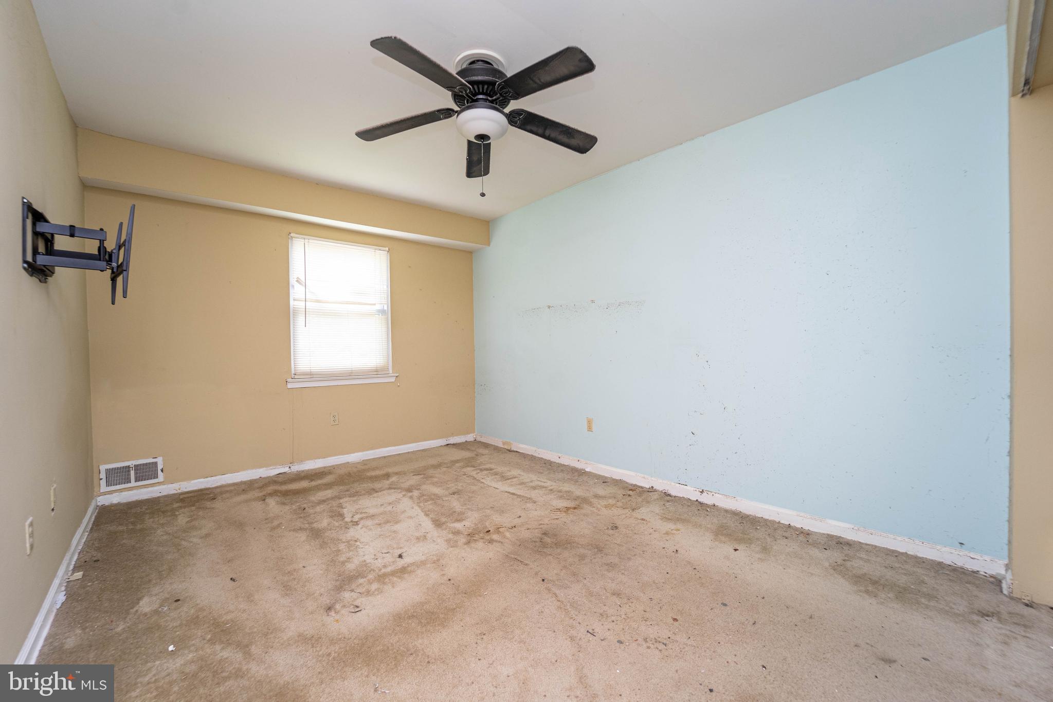 1923 Addison Road South District Heights, MD 20747 - Photo 16 of 30 an empty room with a window and a fan