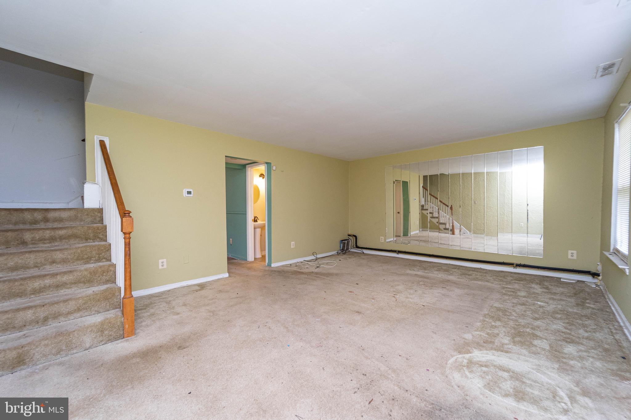 1923 Addison Road South District Heights, MD 20747 - Photo 3 of 30 a view of an empty room with wooden floor and door