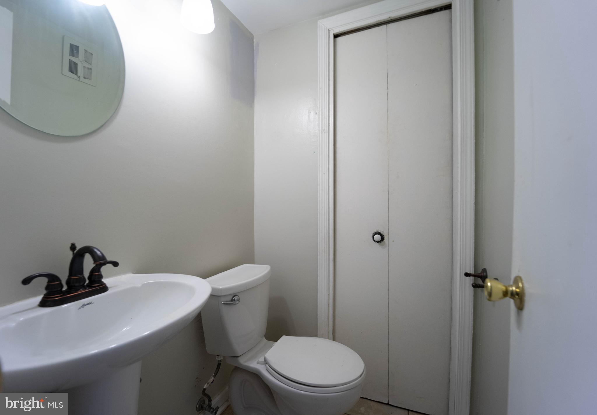 1923 Addison Road South District Heights, MD 20747 - Photo 7 of 30 a bathroom with a sink a toilet and a mirror