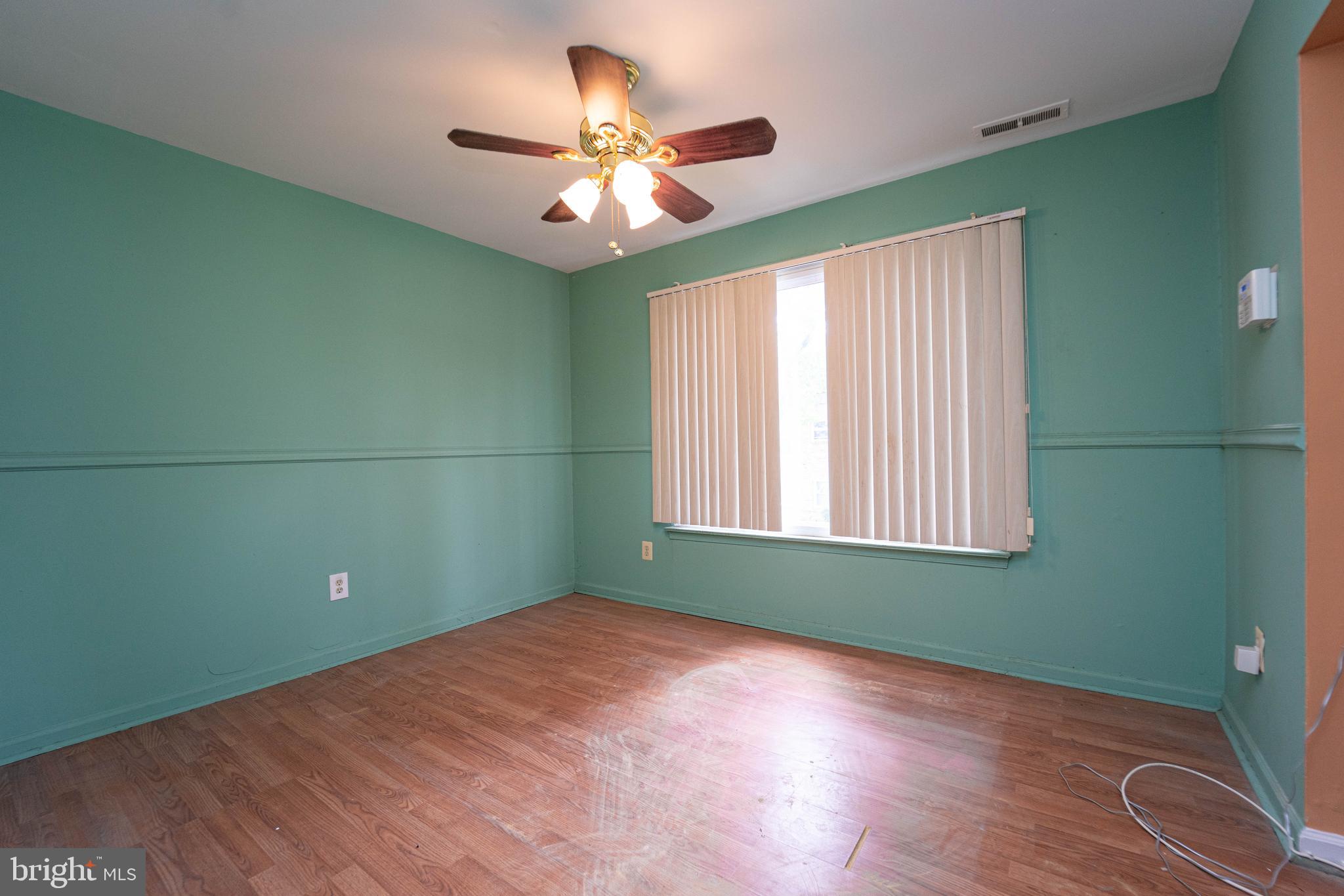 1923 Addison Road South District Heights, MD 20747 - Photo 9 of 30 a view of an empty room with wooden floor and a window