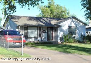 4115 South Travis Street Amarillo, TX 79110 - Photo 1 of 1 a front view of a house with garden