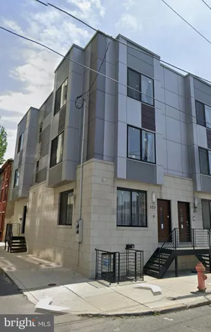 a front view of a building with a road