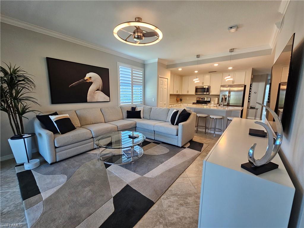 9596 Trevi Court, Unit 5428 Naples, FL 34113 - Photo 1 of 43 a living room with furniture and wooden floor