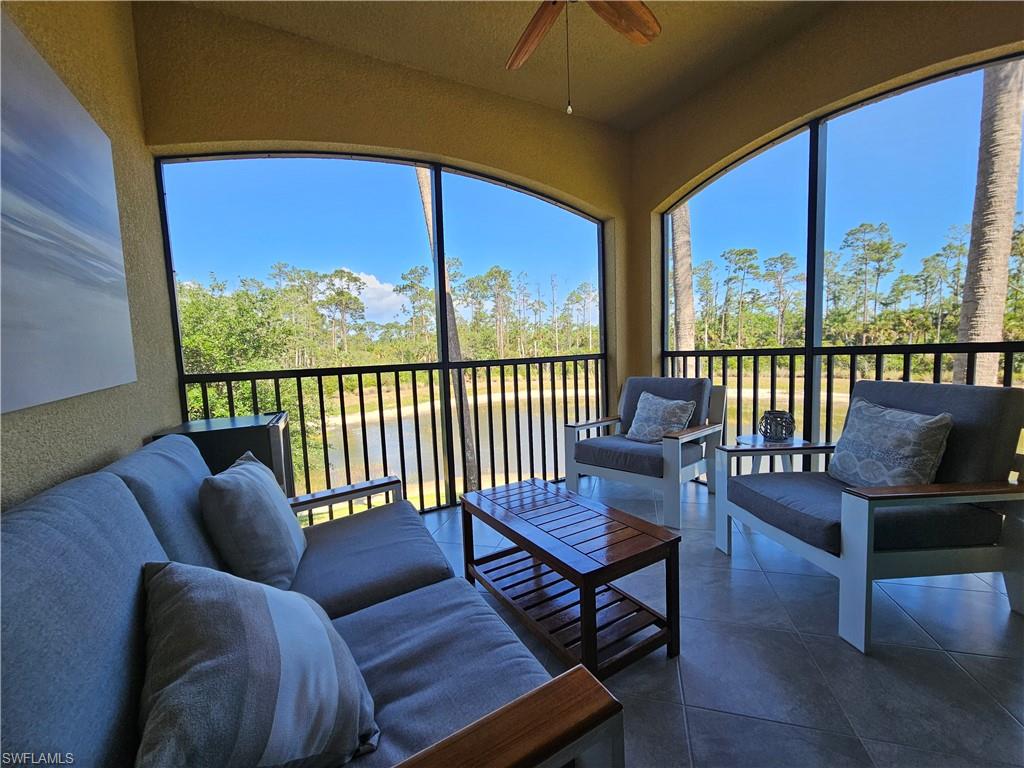 9596 Trevi Court, Unit 5428 Naples, FL 34113 - Photo 17 of 43 a balcony with furniture and wooden floor