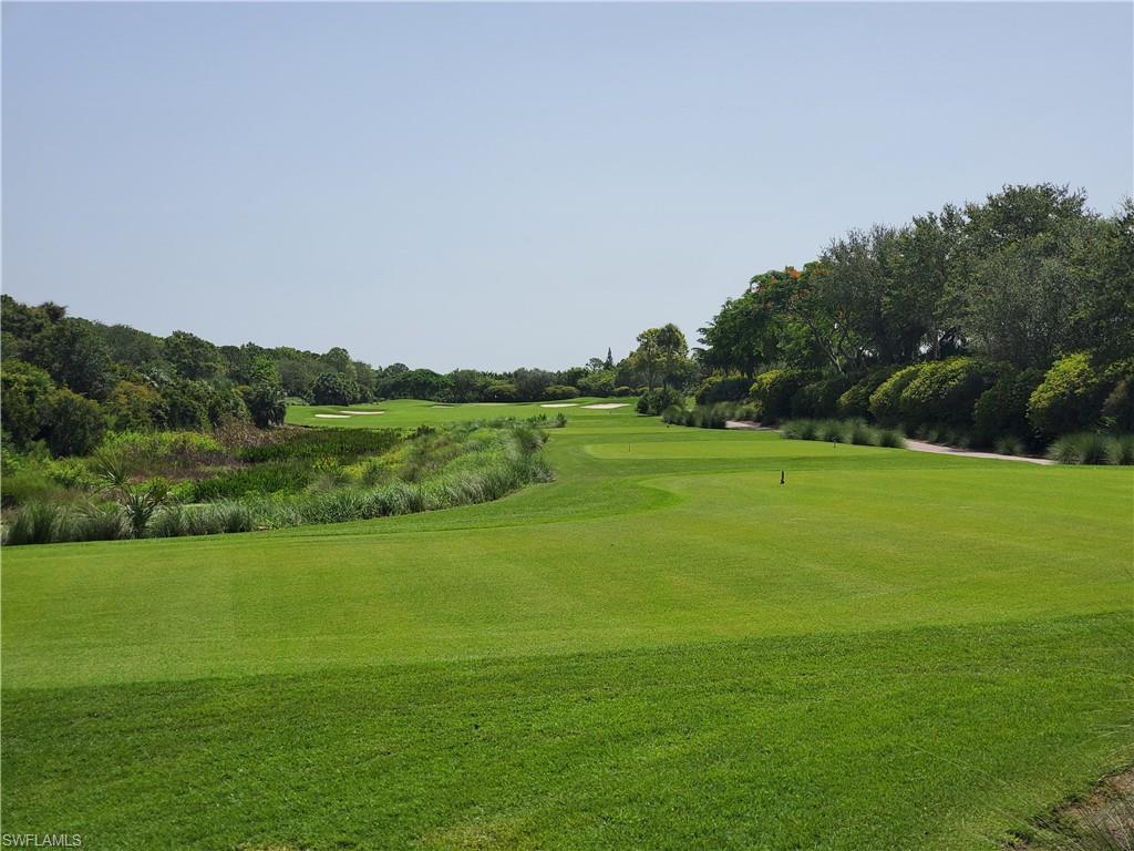 9596 Trevi Court, Unit 5428 Naples, FL 34113 - Photo 38 of 43 a view of a golf course with a lake