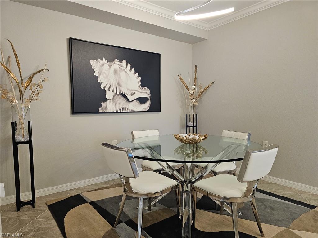 9596 Trevi Court, Unit 5428 Naples, FL 34113 - Photo 7 of 43 a view of a dining room with furniture and wooden floor