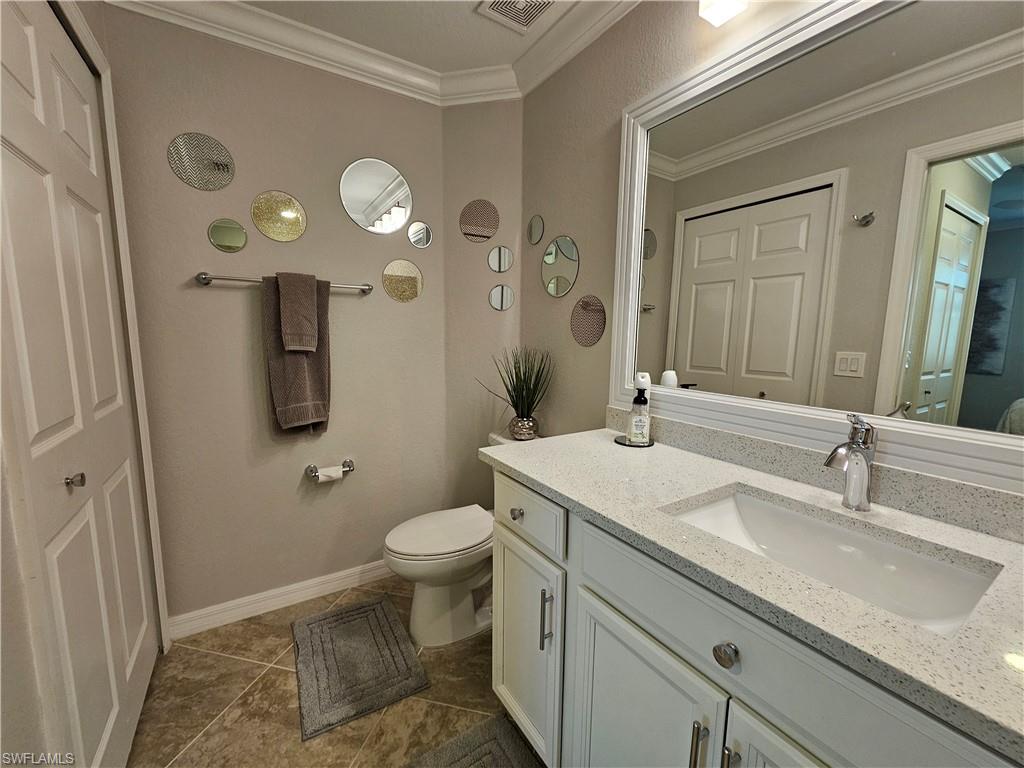 9596 Trevi Court, Unit 5428 Naples, FL 34113 - Photo 10 of 43 a bathroom with a sink and a mirror