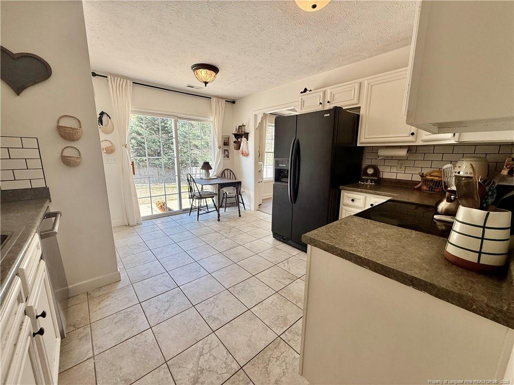 234 Pender Road Spring Lake, NC 28390 - Photo 15 of 39 a kitchen with stainless steel appliances granite countertop a refrigerator sink and stove