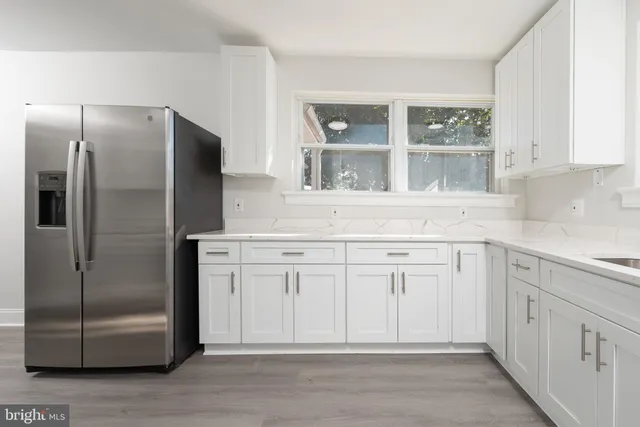 a kitchen with cabinets and stainless steel appliances