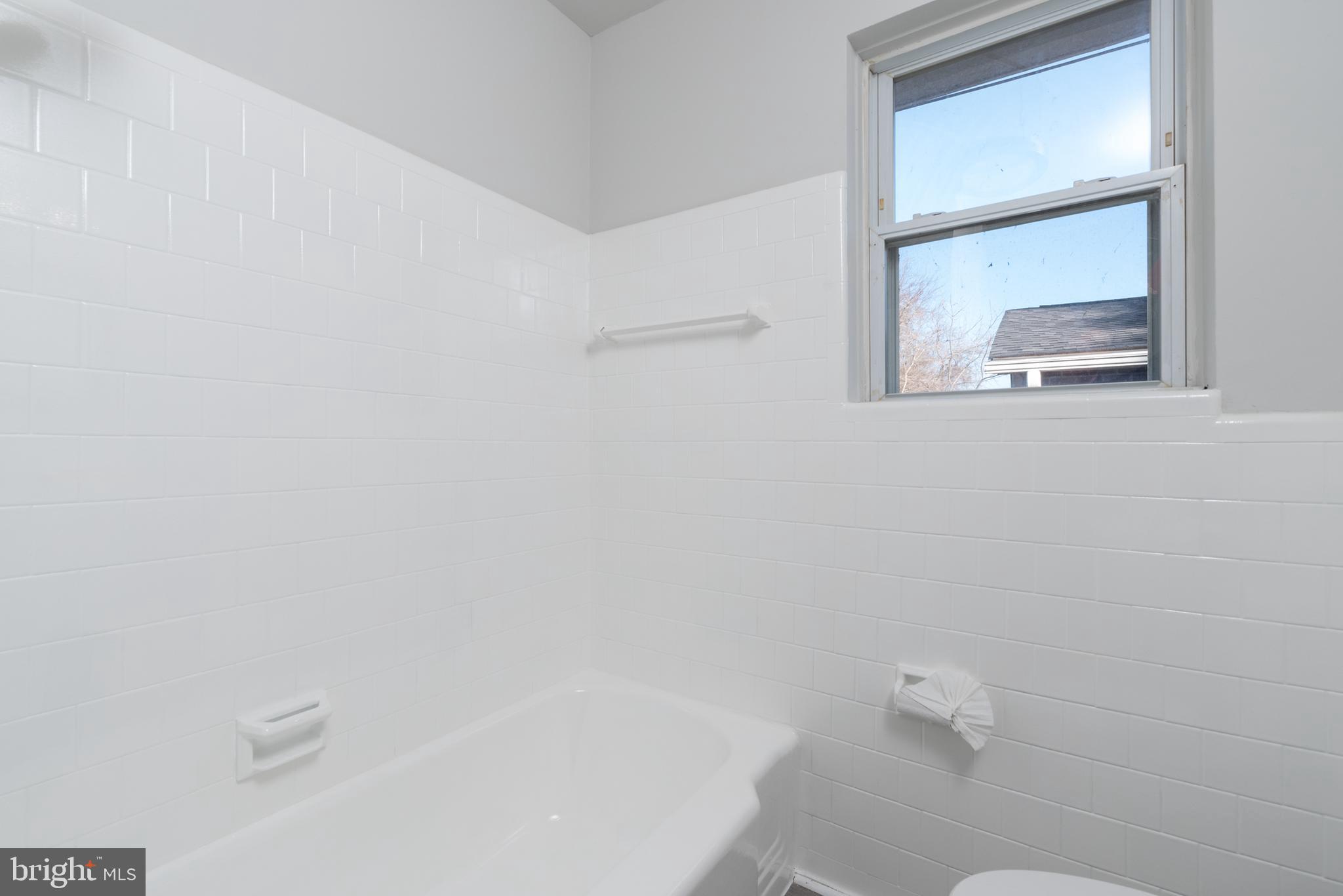 3306 East River Road Petersburg, VA 23803 - Photo 23 of 31 a bathroom with a bathtub and a window