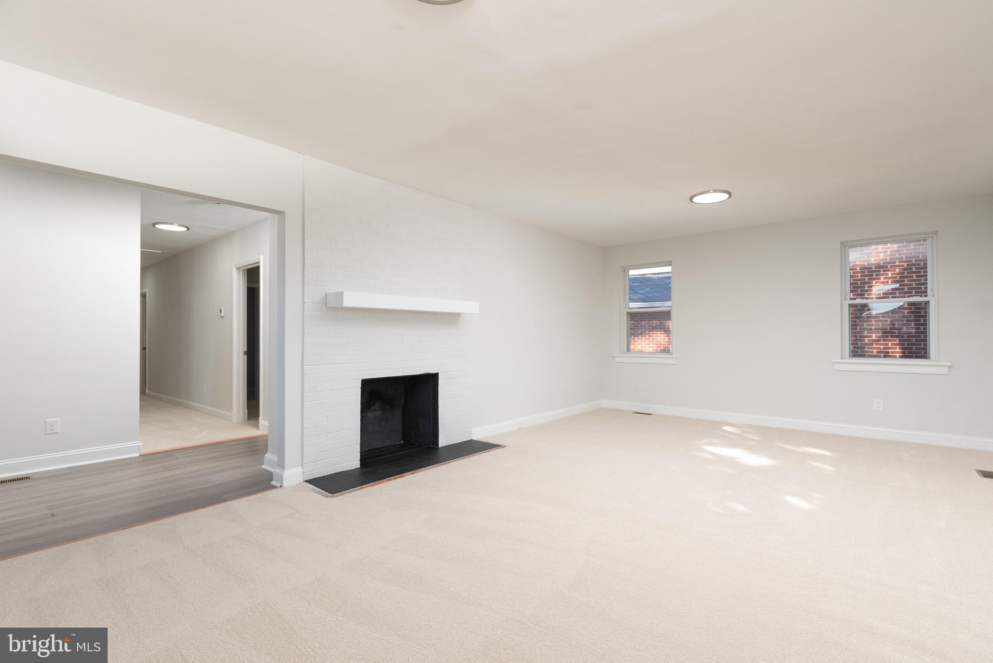 3306 East River Road Petersburg, VA 23803 - Photo 7 of 31 an empty room with windows and fireplace
