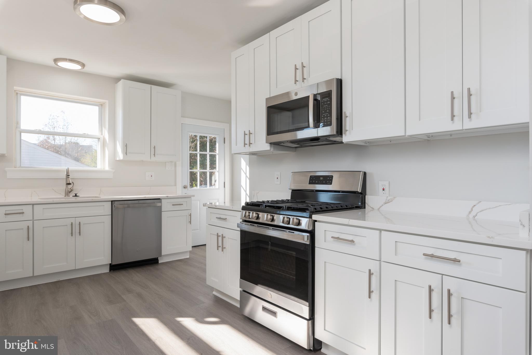3306 East River Road Petersburg, VA 23803 - Photo 10 of 31 a kitchen with white cabinets stainless steel appliances and sink