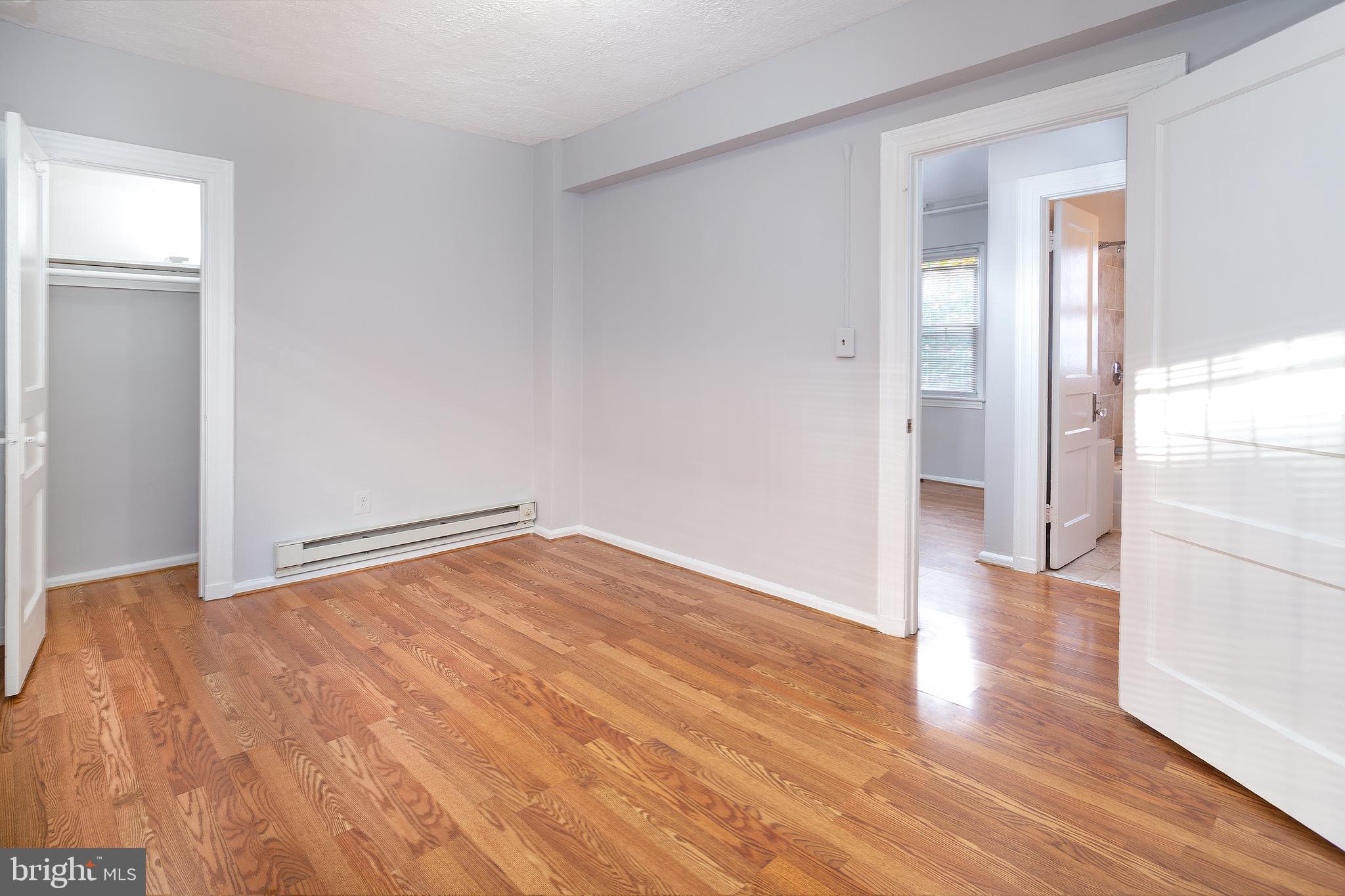 2415 Ontario Road Northwest, Unit 101 Washington, DC 20009 - Photo 18 of 22 a view of an empty room and wooden floor