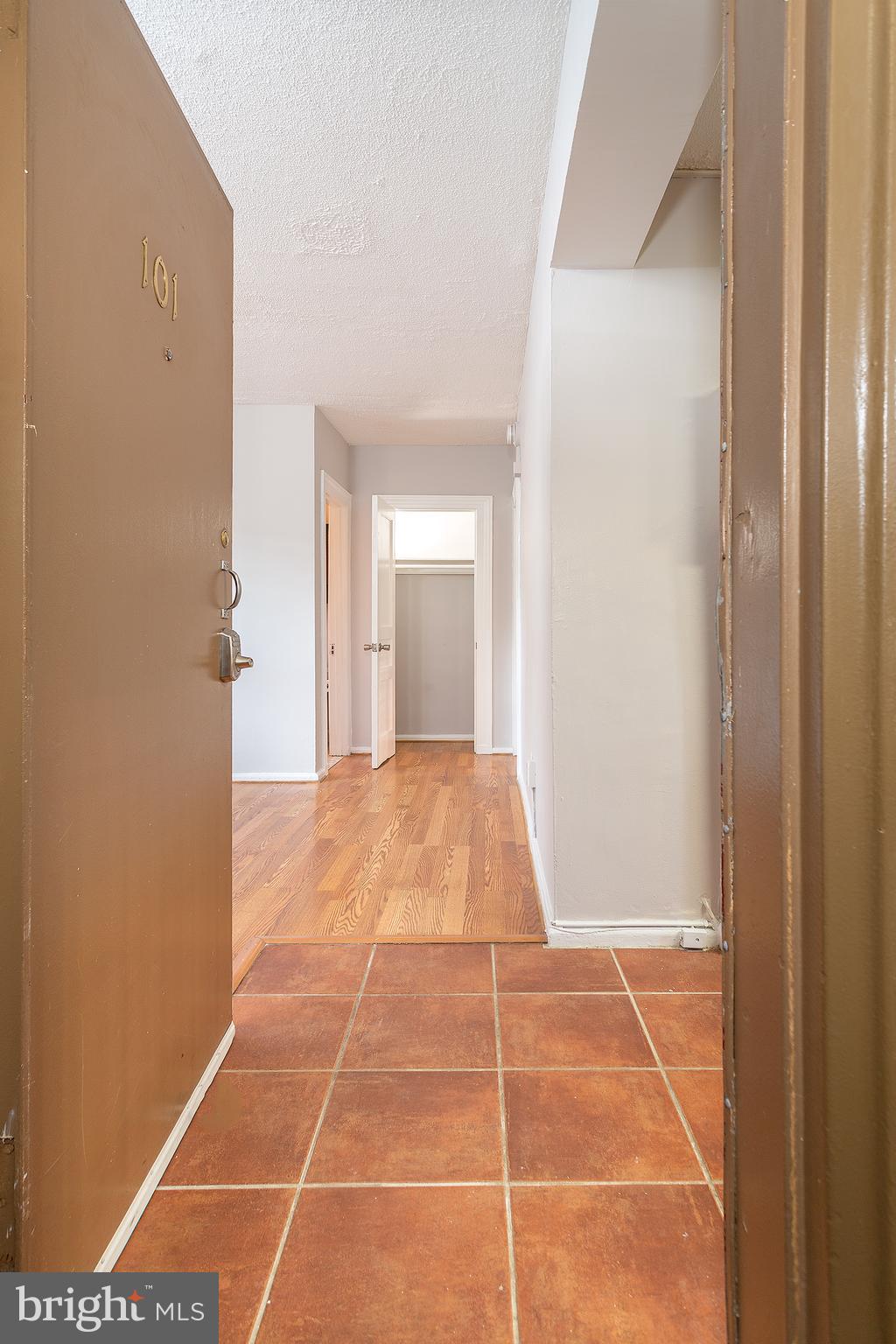 2415 Ontario Road Northwest, Unit 101 Washington, DC 20009 - Photo 3 of 22 a view of an empty room with wooden door