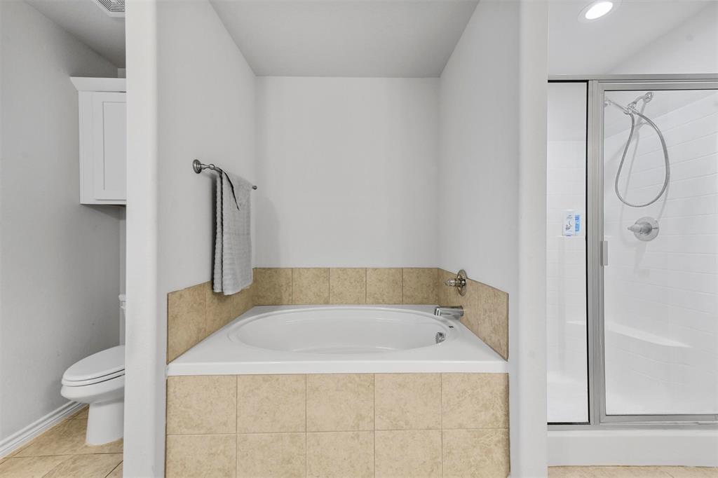 226 County Road 4869 Azle, TX 76020 - Photo 13 of 28 a bathroom with a granite countertop sink a toilet and shower