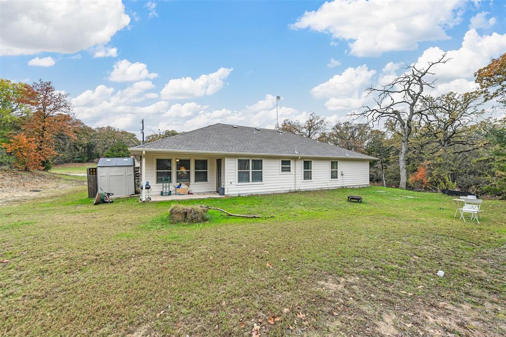 226 County Road 4869 Azle, TX 76020 - Photo 18 of 28 a view of a house with a big yard and large trees