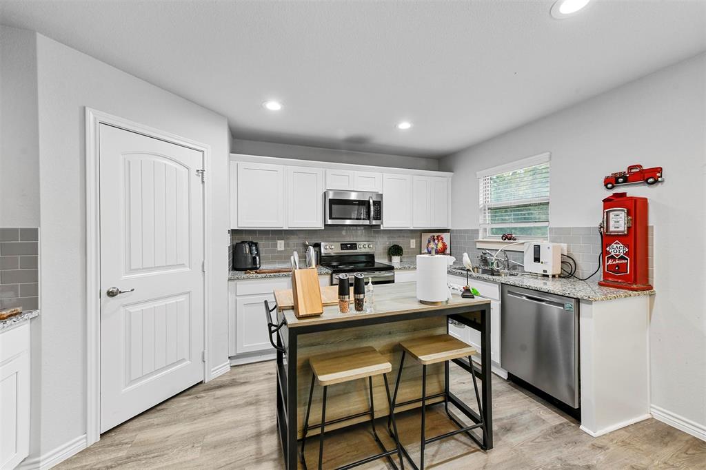 226 County Road 4869 Azle, TX 76020 - Photo 21 of 28 a kitchen with stainless steel appliances granite countertop a refrigerator and a stove top oven