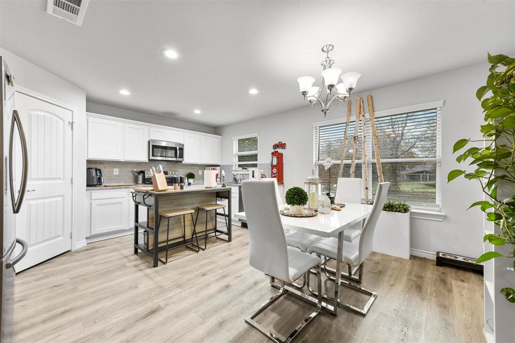 226 County Road 4869 Azle, TX 76020 - Photo 23 of 28 a view of a dining room with furniture a kitchen and chandelier