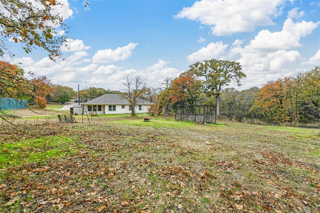 226 County Road 4869 Azle, TX 76020 - Photo 27 of 28 a view of a garden with a building