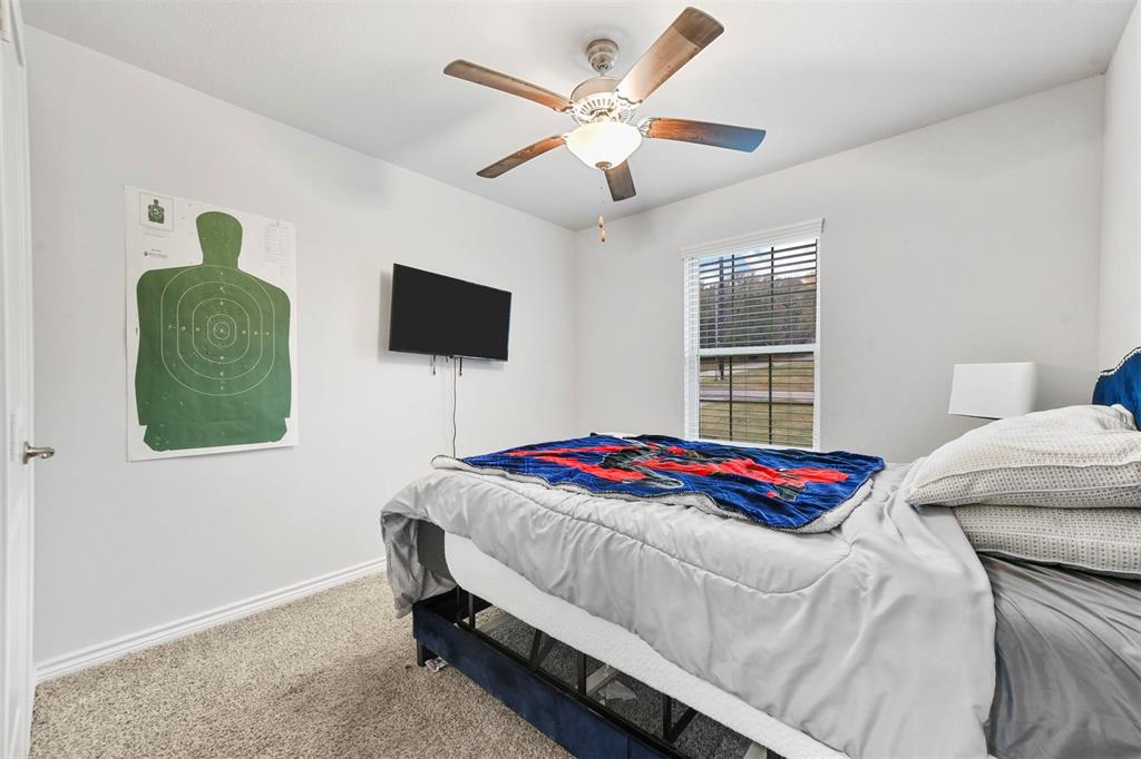 226 County Road 4869 Azle, TX 76020 - Photo 8 of 28 a bedroom with a bed and a flat screen tv