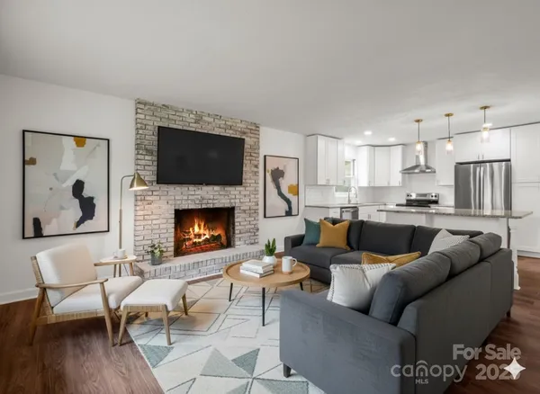 a living room with furniture a fireplace and a flat screen tv