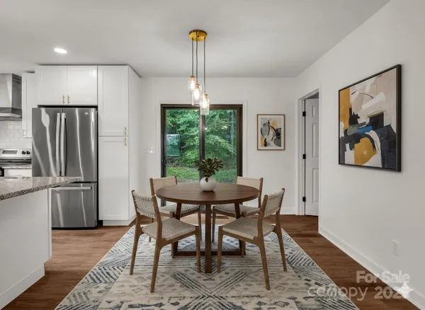 a dining room with furniture a window and a refrigerator
