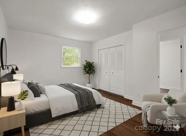 a bedroom with a bed and a couch