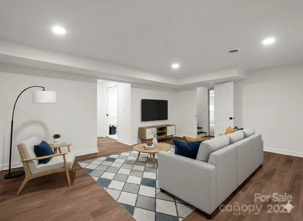 a living room with furniture and a flat screen tv