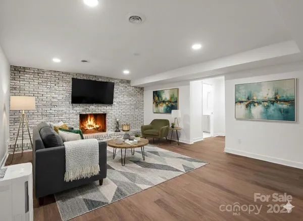 a living room with fireplace furniture and a flat screen tv