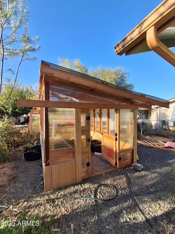 a backyard of a house with barbeque oven table and chairs