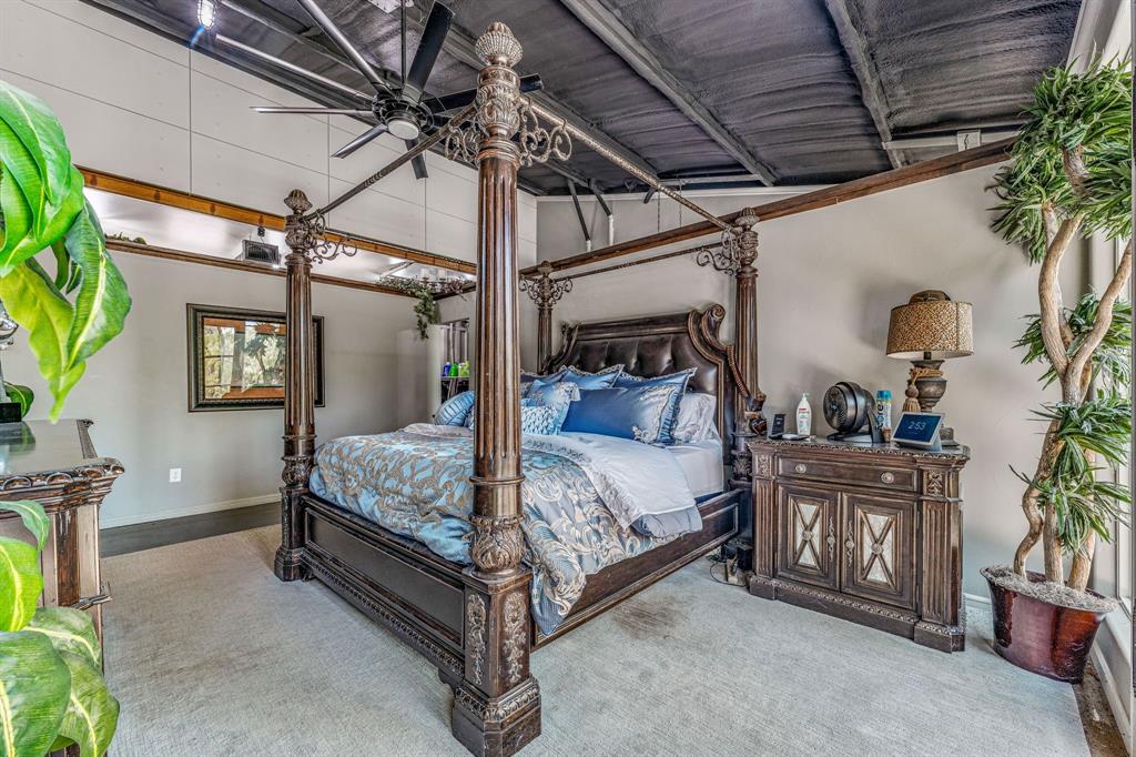 886 Mitchell Hill Road Gordon, TX 76453 - Photo 13 of 34 a bedroom with a bed and a chandelier