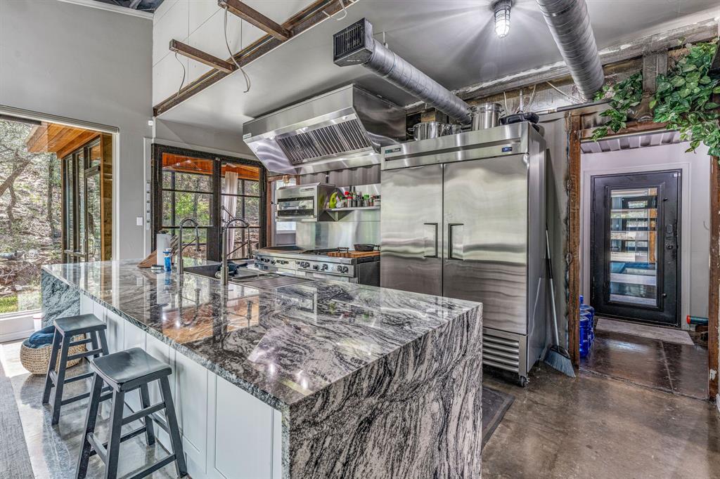 886 Mitchell Hill Road Gordon, TX 76453 - Photo 15 of 34 a kitchen with a table and chairs