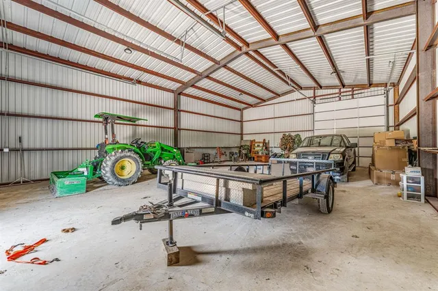 a bedroom with a bed couch and a window