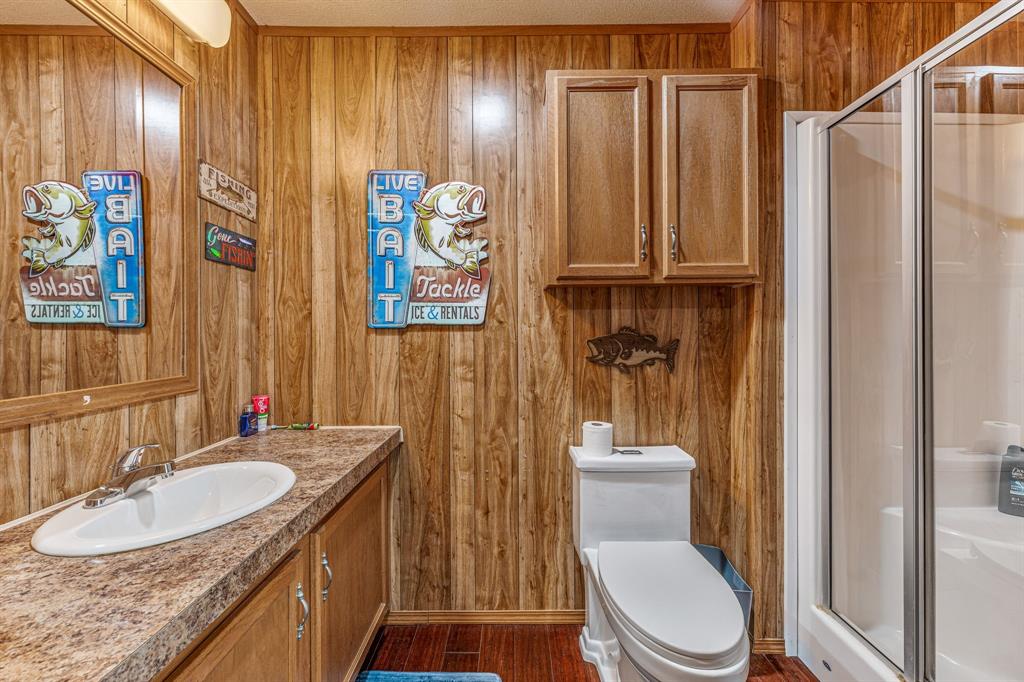 886 Mitchell Hill Road Gordon, TX 76453 - Photo 21 of 34 a bathroom with a granite countertop sink toilet and shower