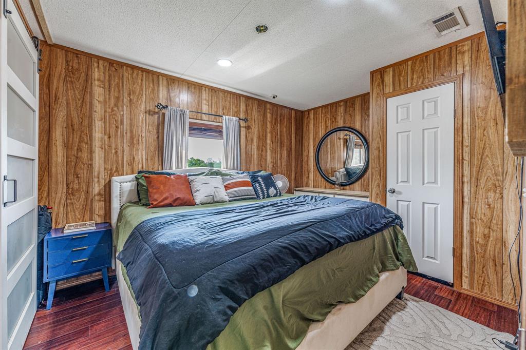 886 Mitchell Hill Road Gordon, TX 76453 - Photo 22 of 34 a bed sitting in a bedroom next to a window