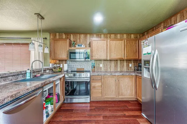 an aerial view of a house with a yard