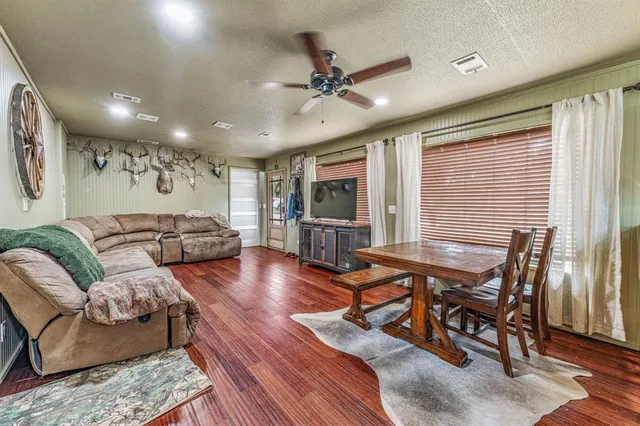 an aerial view of residential houses with outdoor space and trees