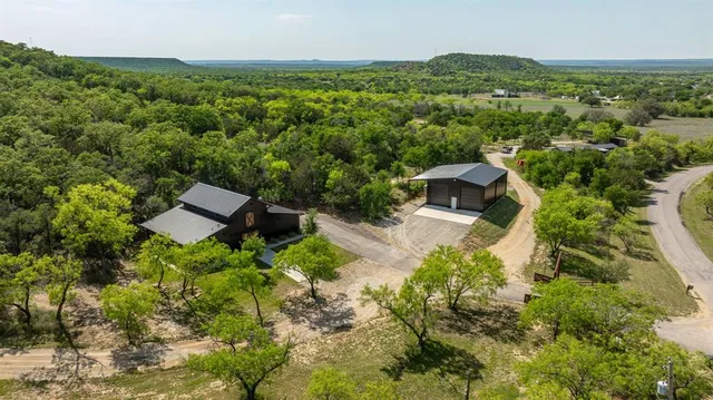 a view of a green field with lots of bushes