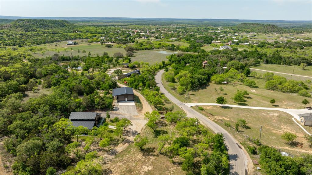 886 Mitchell Hill Road Gordon, TX 76453 - Photo 26 of 34 an aerial view of residential houses with outdoor space and trees
