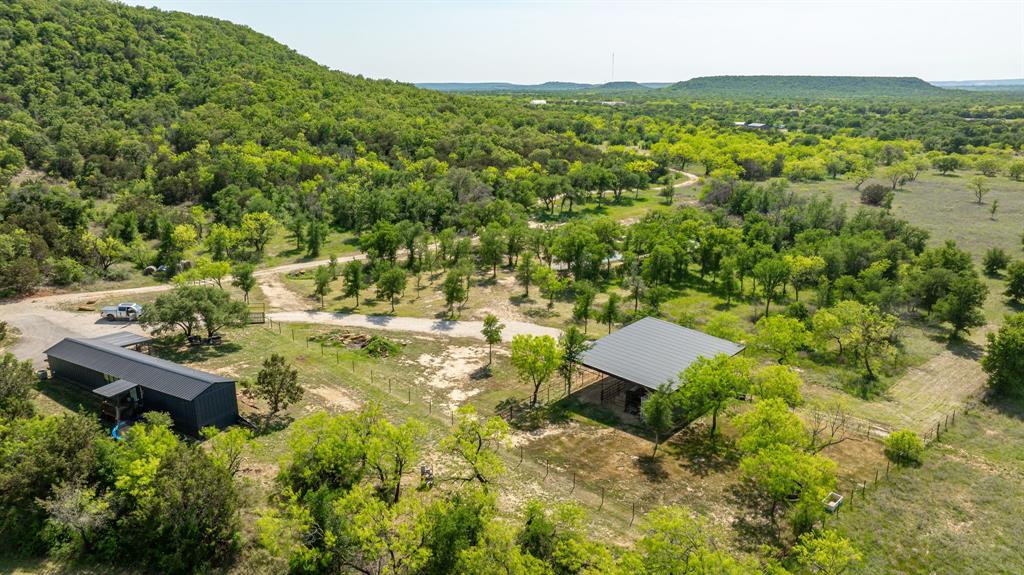 886 Mitchell Hill Road Gordon, TX 76453 - Photo 30 of 34 a view of a house with a yard and trees