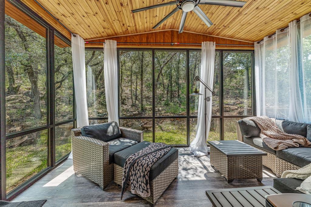 886 Mitchell Hill Road Gordon, TX 76453 - Photo 8 of 34 a living room with furniture and a floor to ceiling window