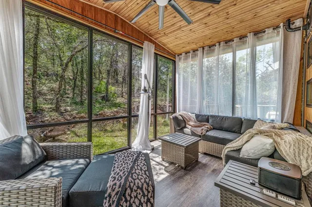 a bathroom with a granite countertop sink a toilet and a window