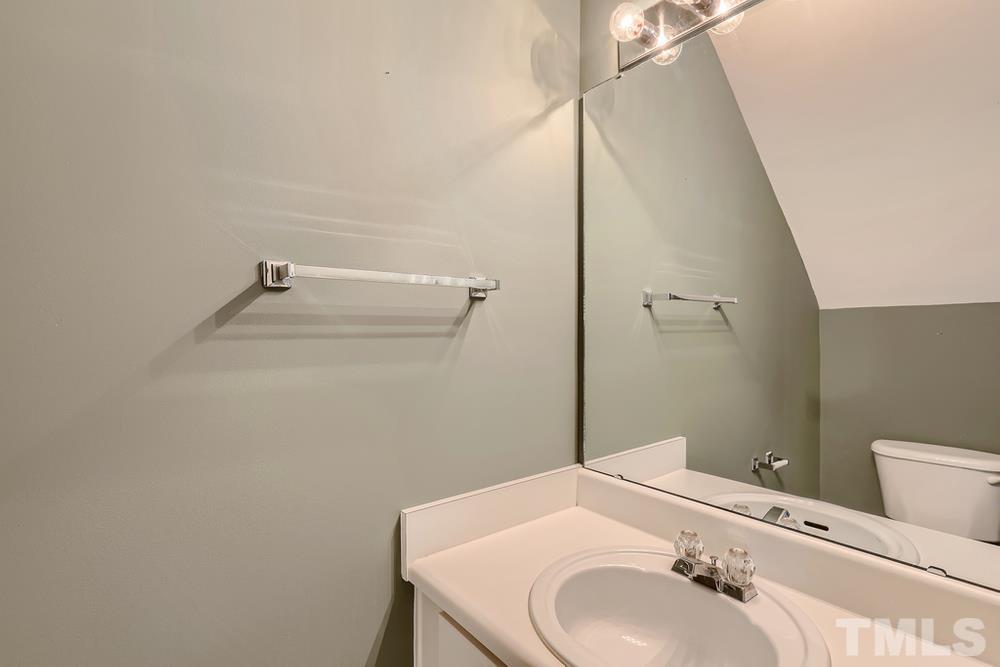 8157 Rhiannon Road Raleigh, NC 27613 - Photo 14 of 27 a bathroom with a sink and a mirror