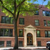 a front view of a residential apartment building with a yard