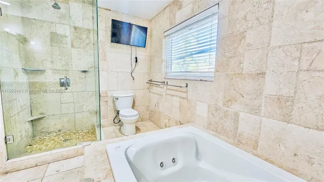 a bathroom with a bathtub and shower
