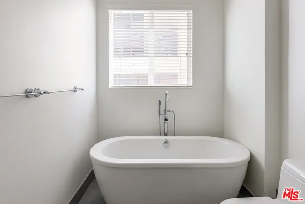 a white bath tub sitting next to a window