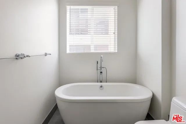 a white bath tub sitting next to a window