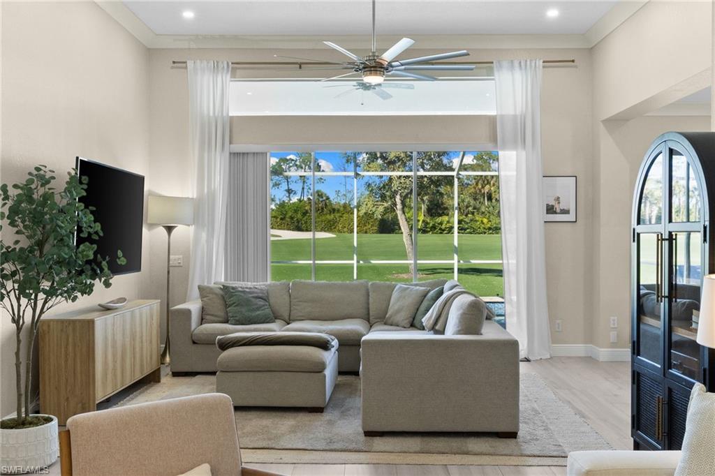 1869 Pondside Lane Naples, FL 34109 - Photo 1 of 34 Living area featuring light wood-style floors, ceiling fan, and ornamental molding